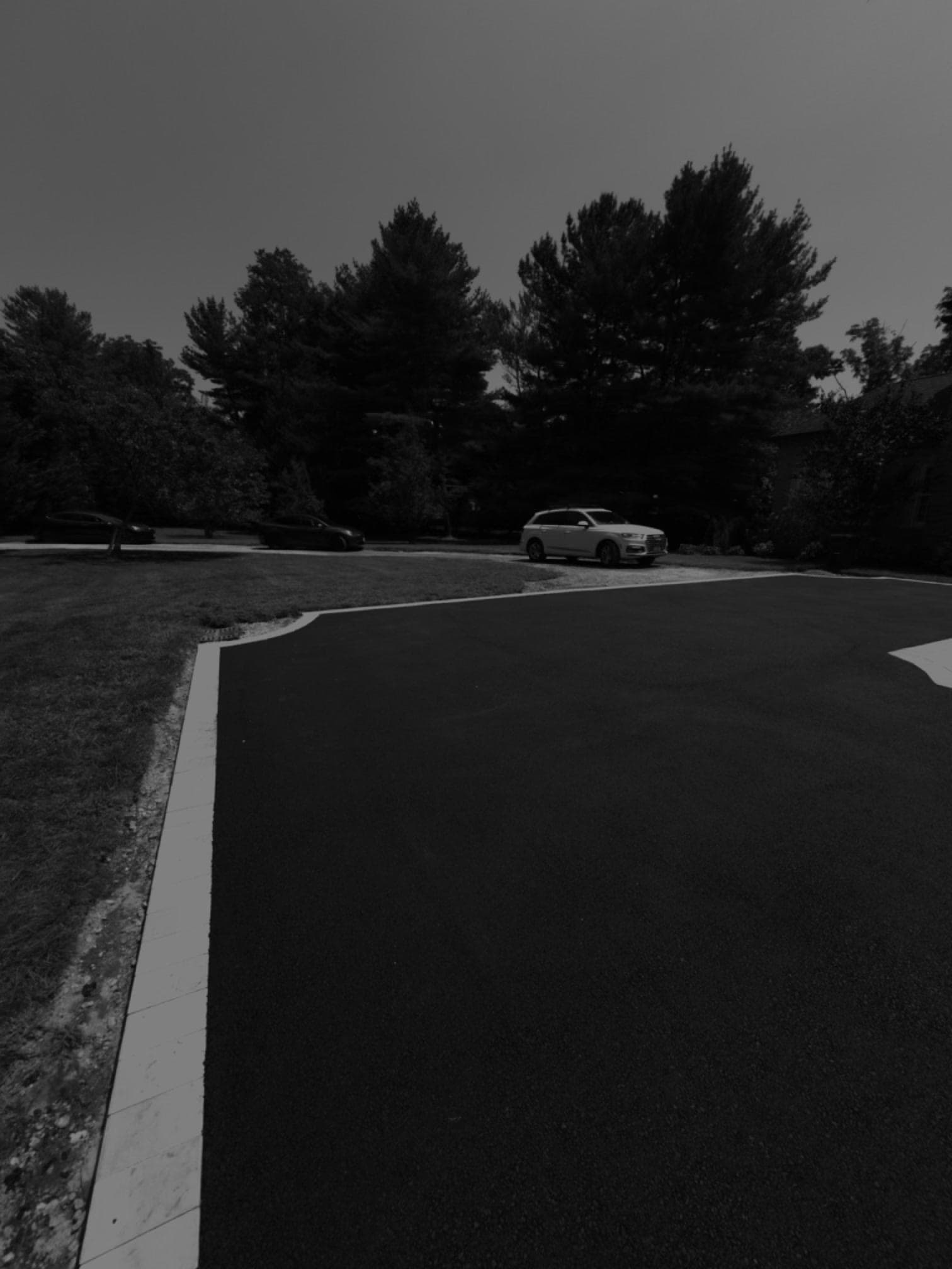 Paver border detail along estate driveway curve in Lloyd Harbor