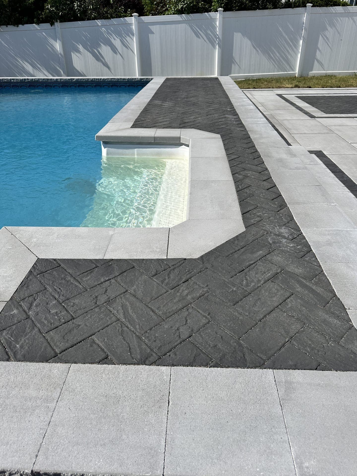 Herringbone paver border detail with pool waterfall spillover