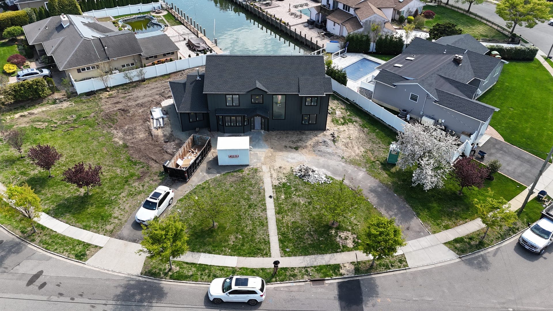 Before: bare dirt front yard with no driveway or landscaping at Massapequa waterfront property
