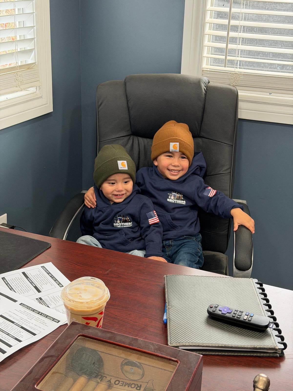 Kids in Brothers Paving hoodies at the office