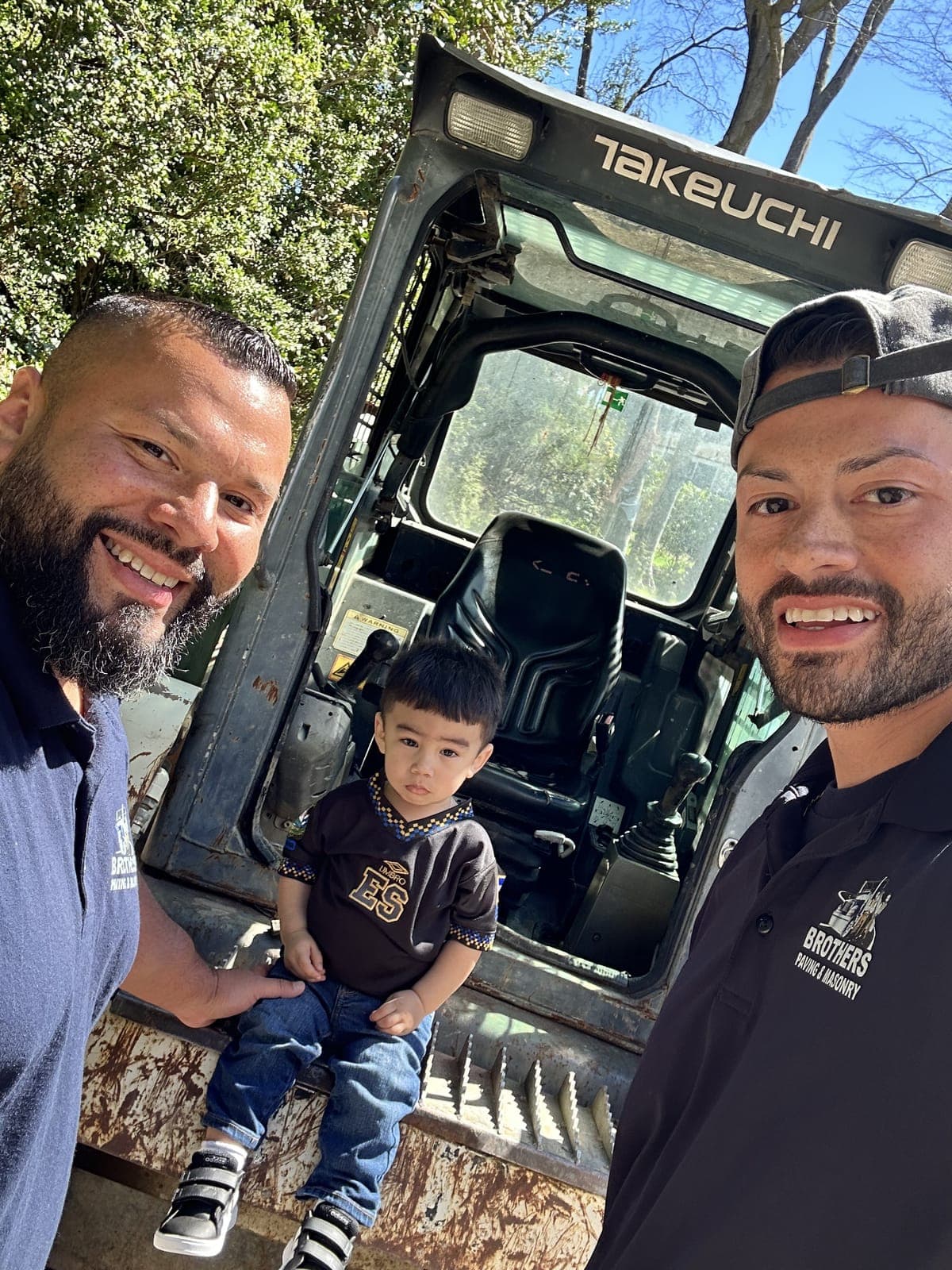 The brothers — owners of Brothers Paving & Masonry — with family on the jobsite