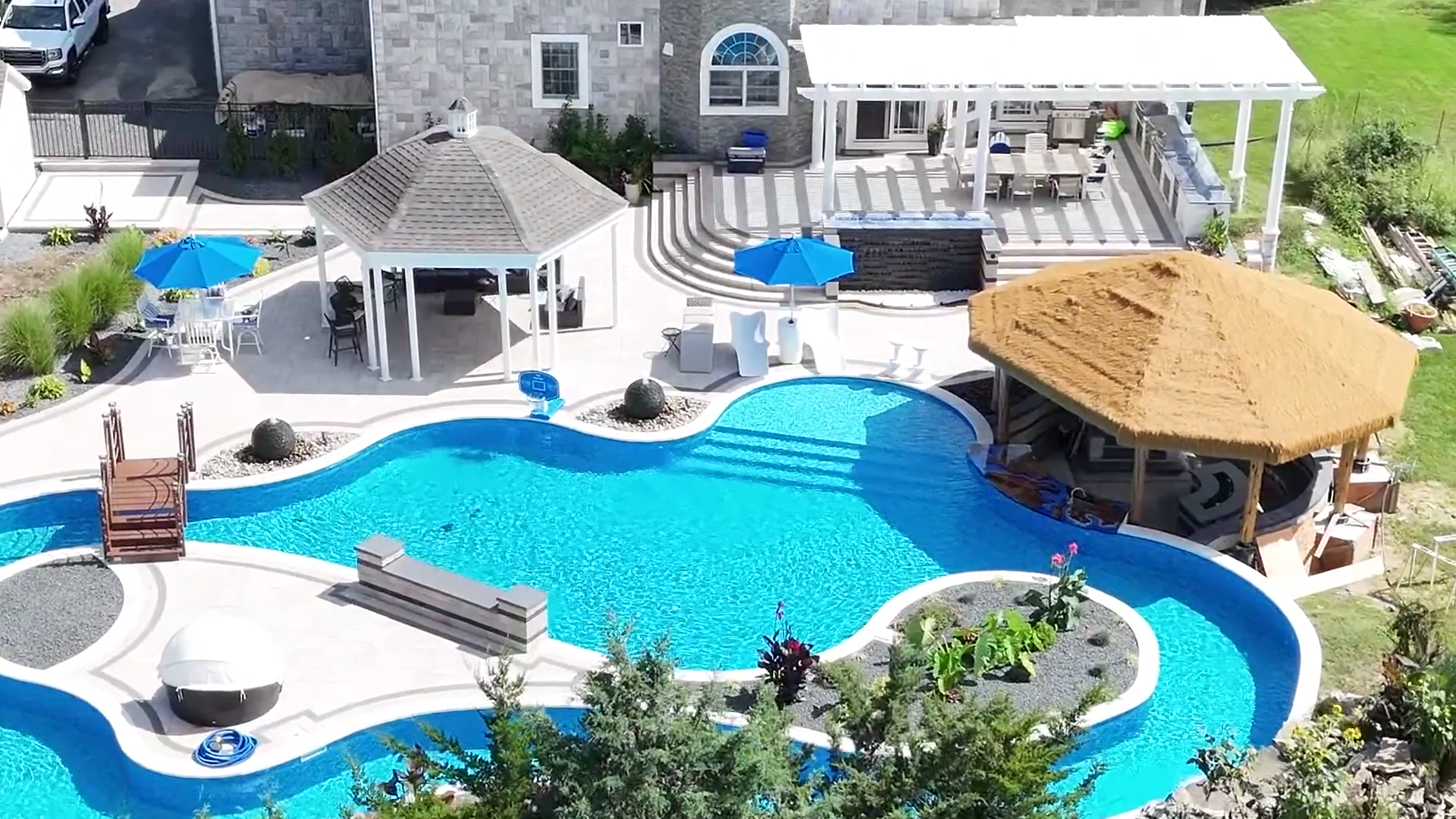 Aerial of the finished lazy river, planted island and palapa in East Northport, Long Island
