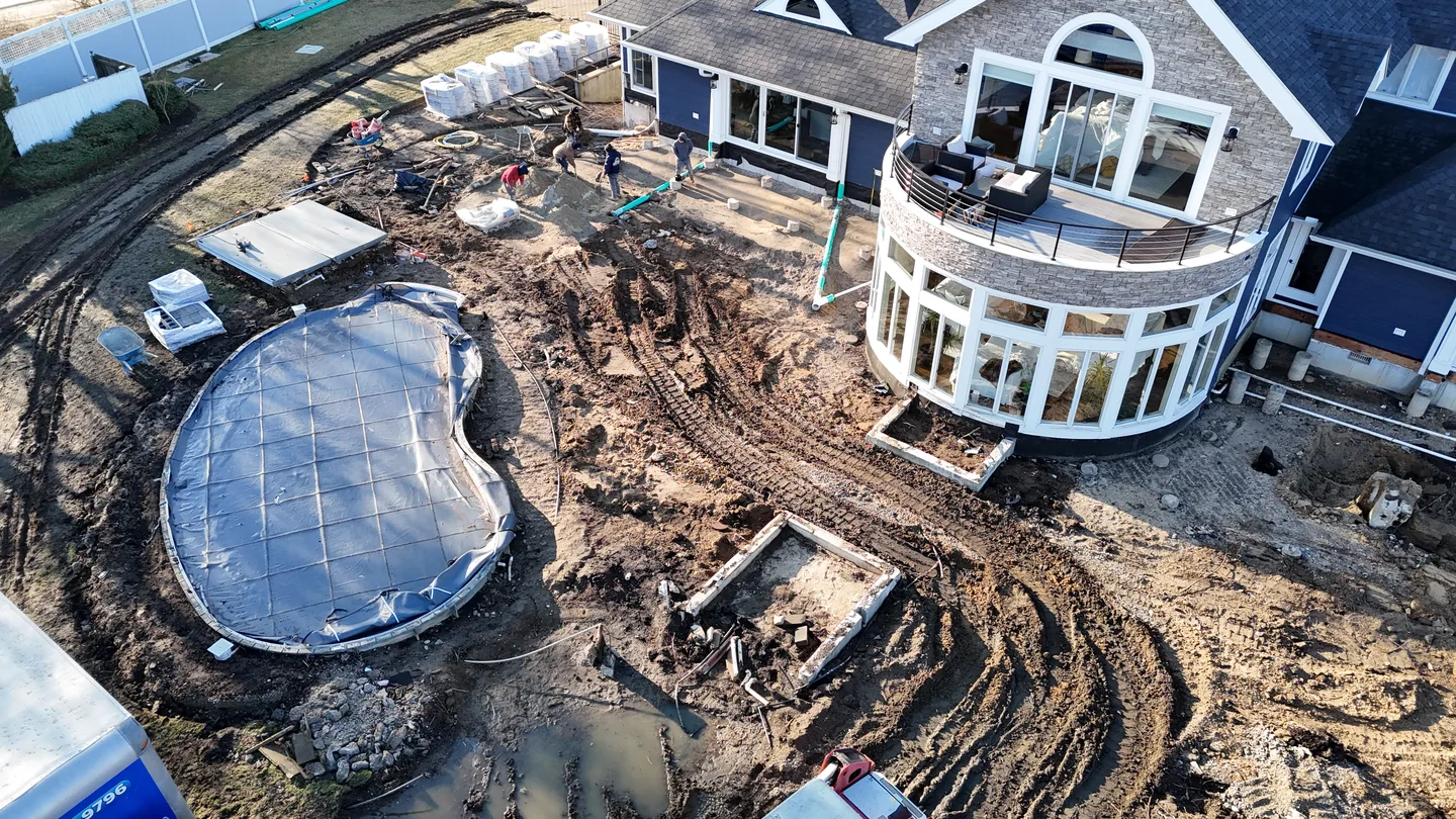 Overhead of the pool shell and bare winter ground during construction, Great River