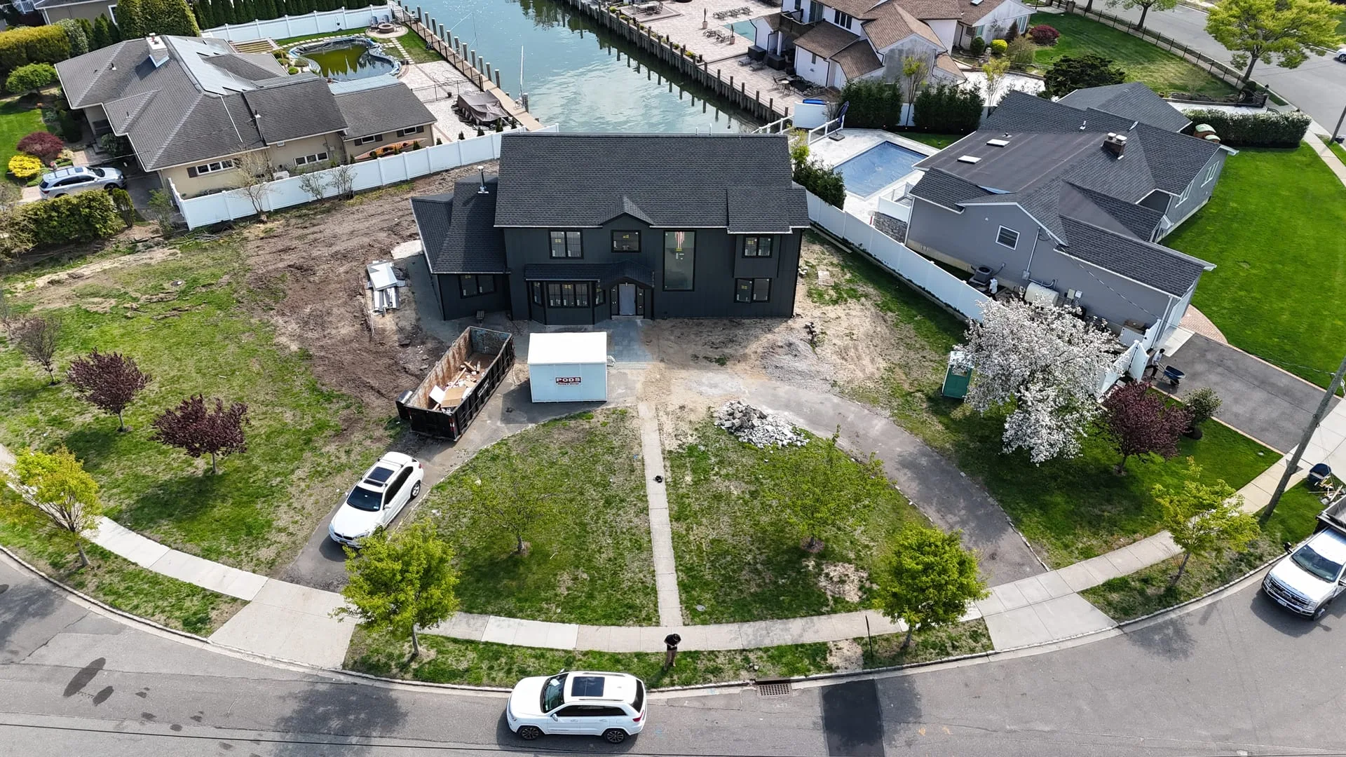 Before: bare dirt front yard with no driveway or landscaping at Massapequa waterfront property