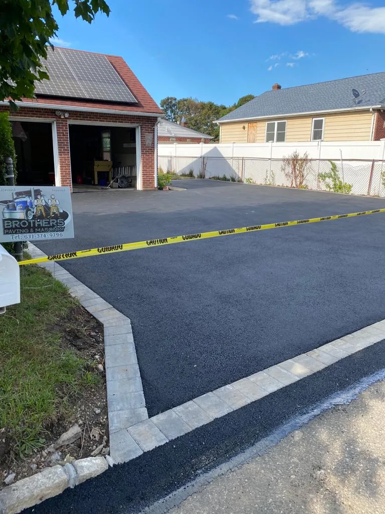 Fresh asphalt driveway with Belgian block border in Massapequa, Long Island