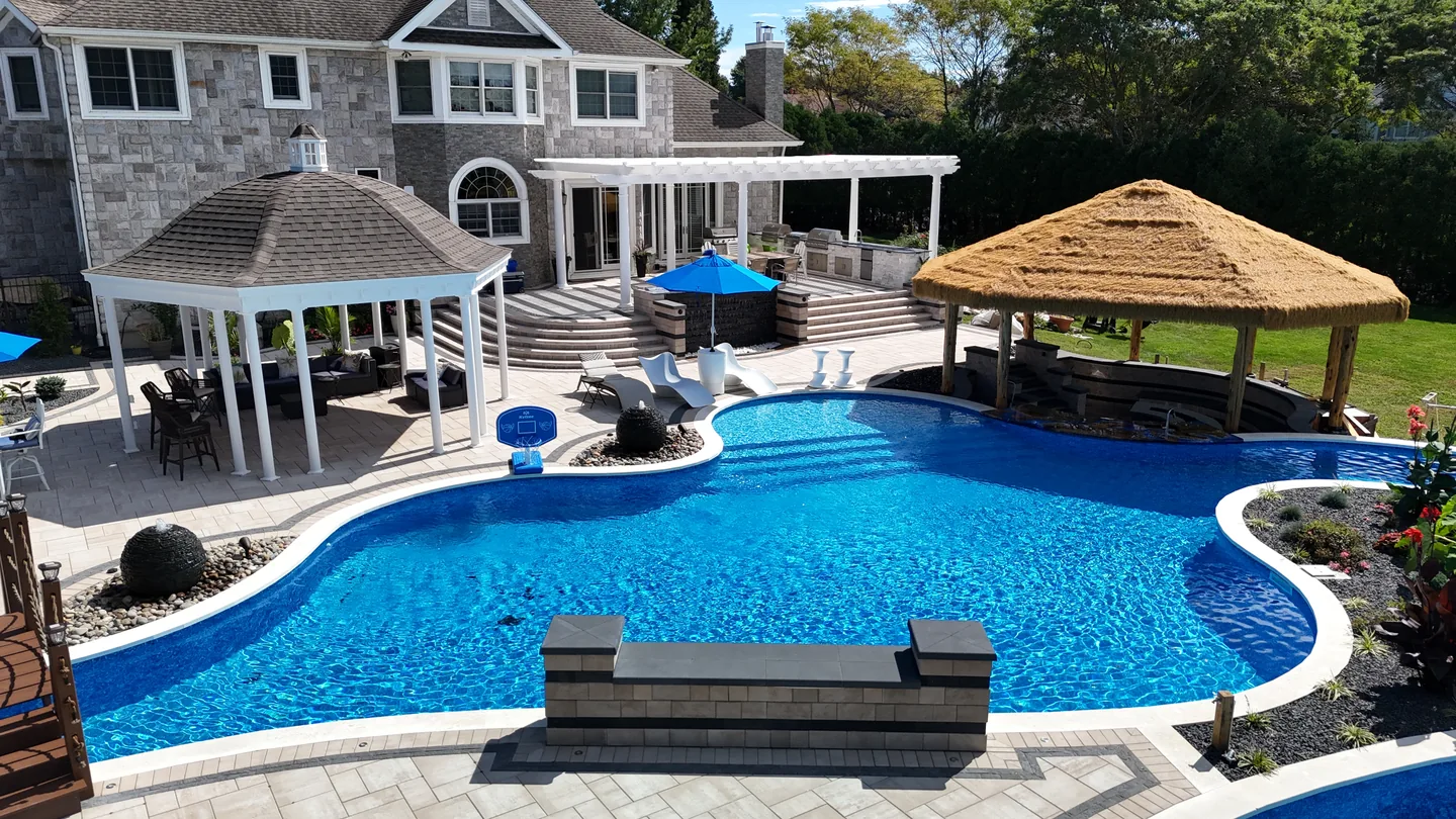 The deck, palapa and pool read together across the rear yard, East Northport