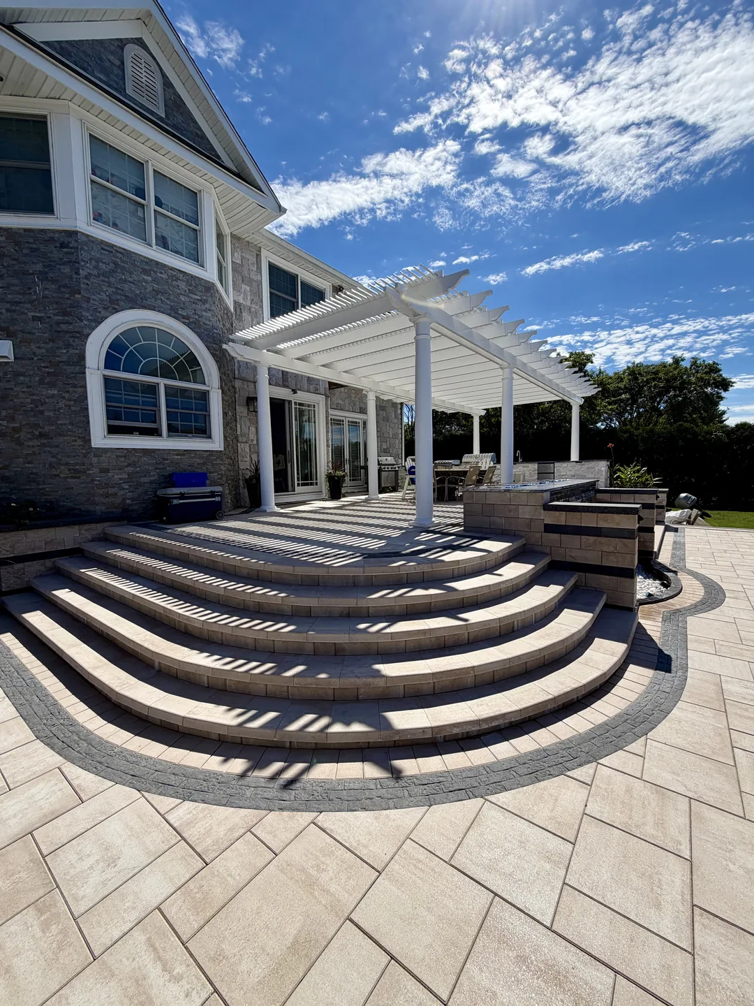 Radius step treads and large-format paver deck finished around the curve, East Northport
