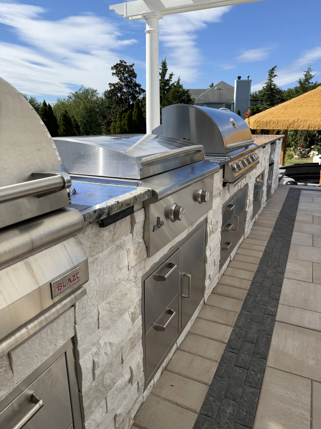 Built-in grill and cabinetry in the outdoor kitchen, East Northport