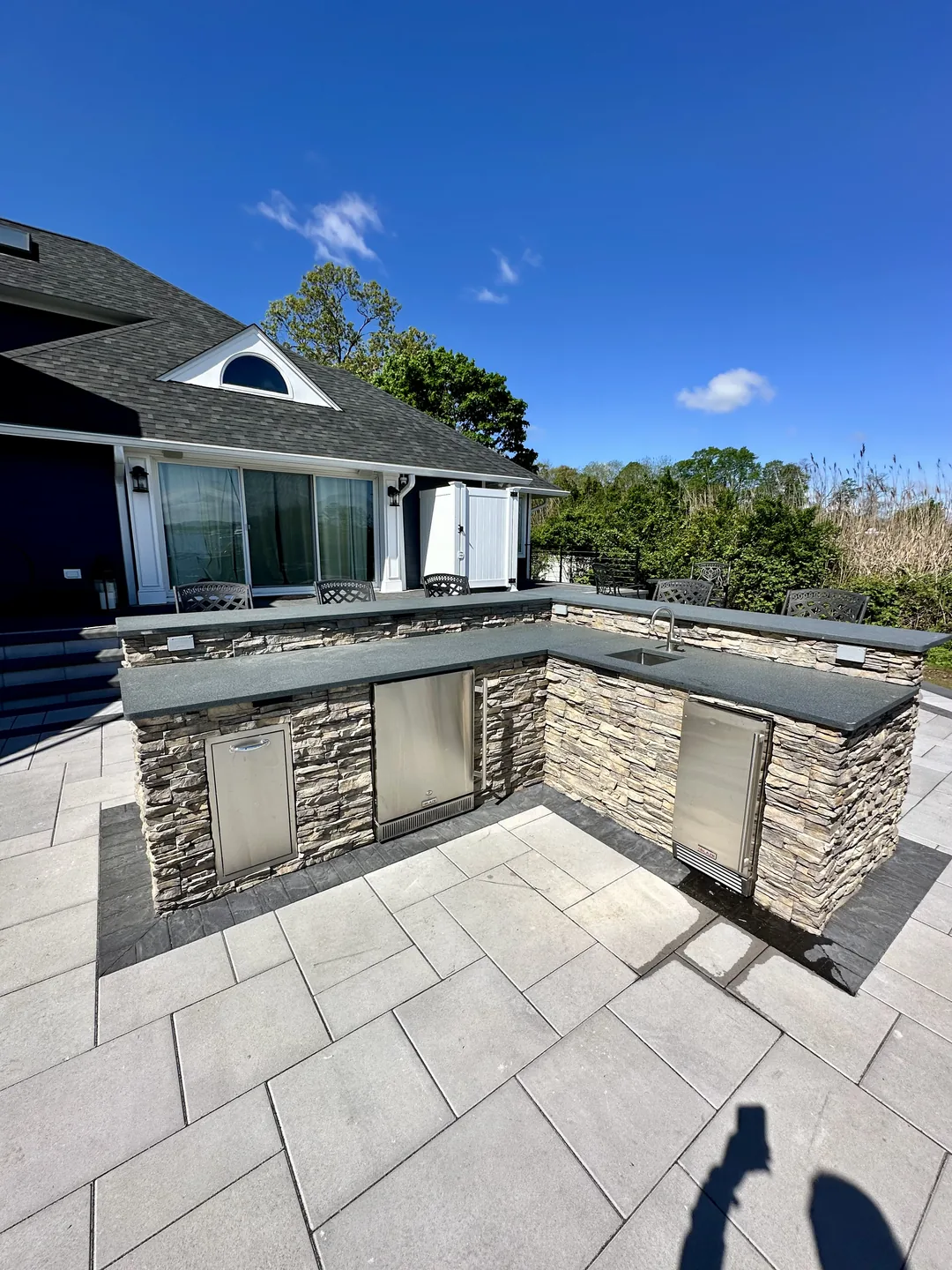 Outdoor kitchen run in stacked stone beside the house, Great River