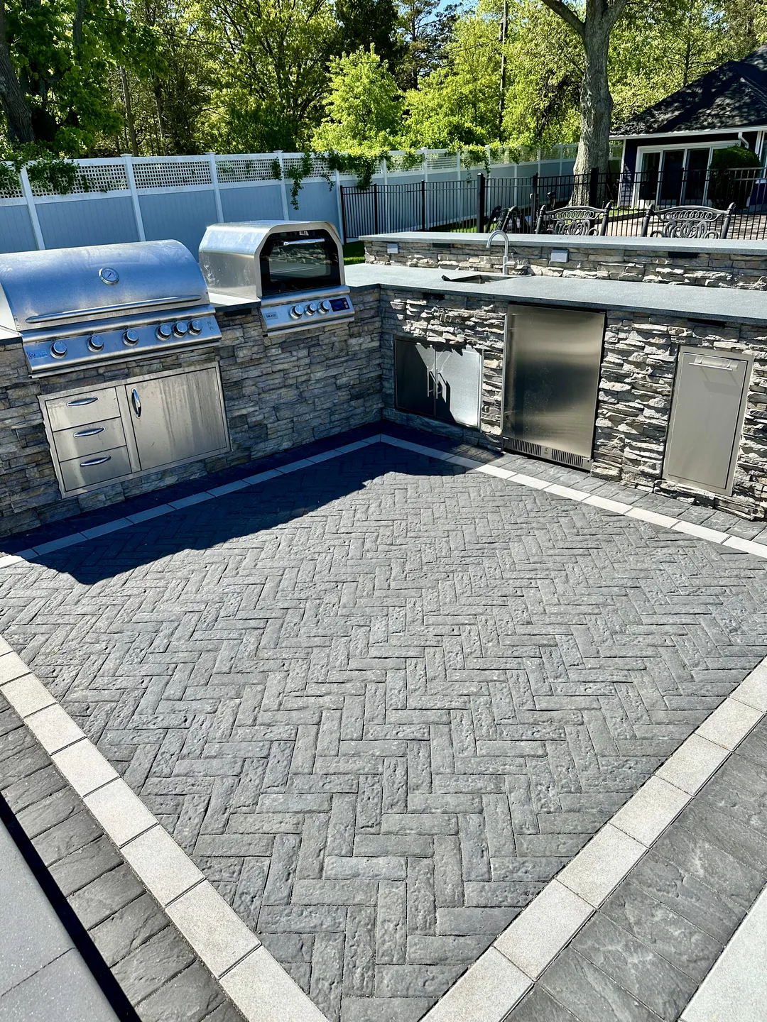 Herringbone paver approach running alongside the outdoor kitchen, Great River