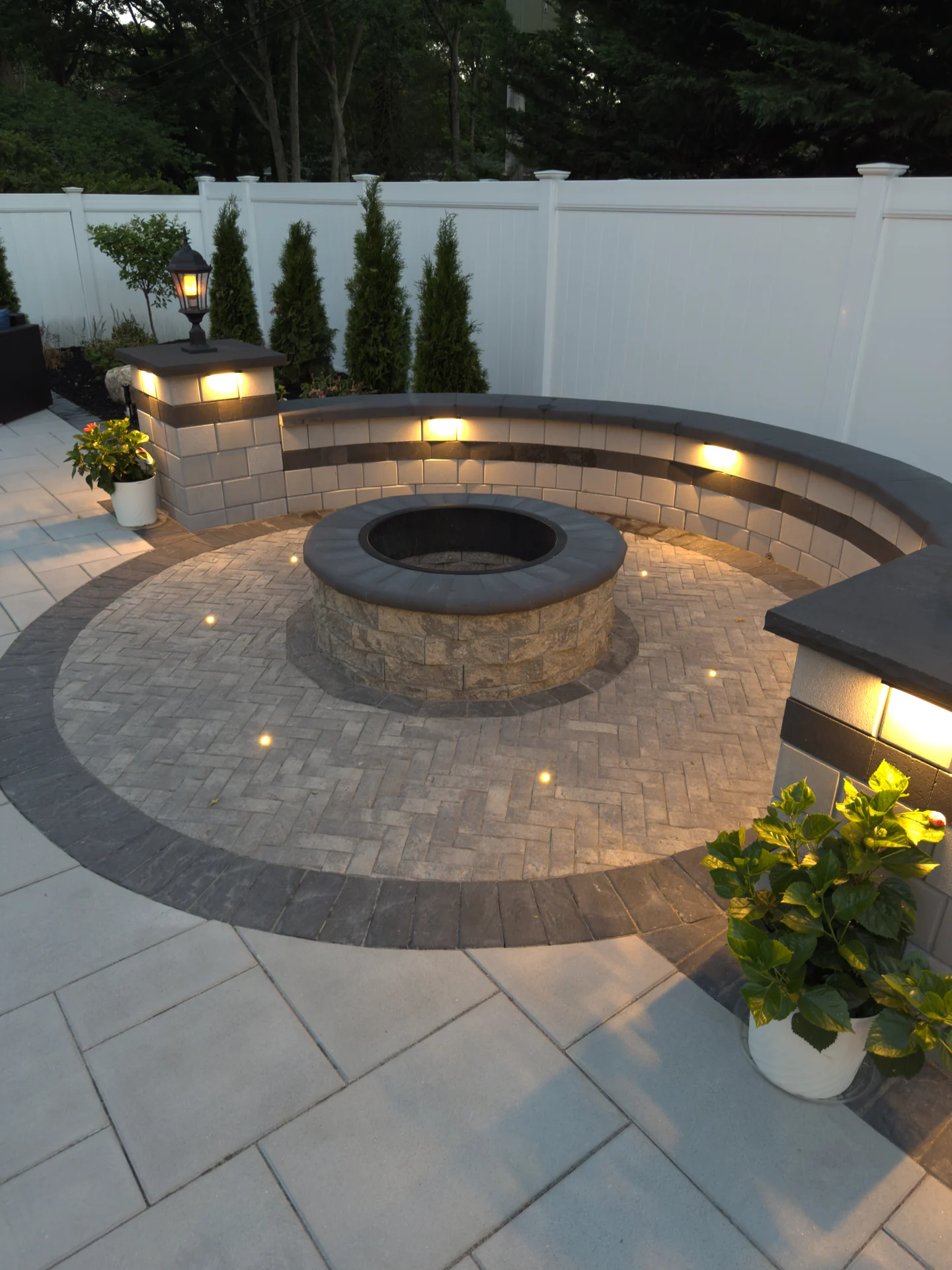 Circular raised fire terrace with surrounding lighting at dusk, Nesconset