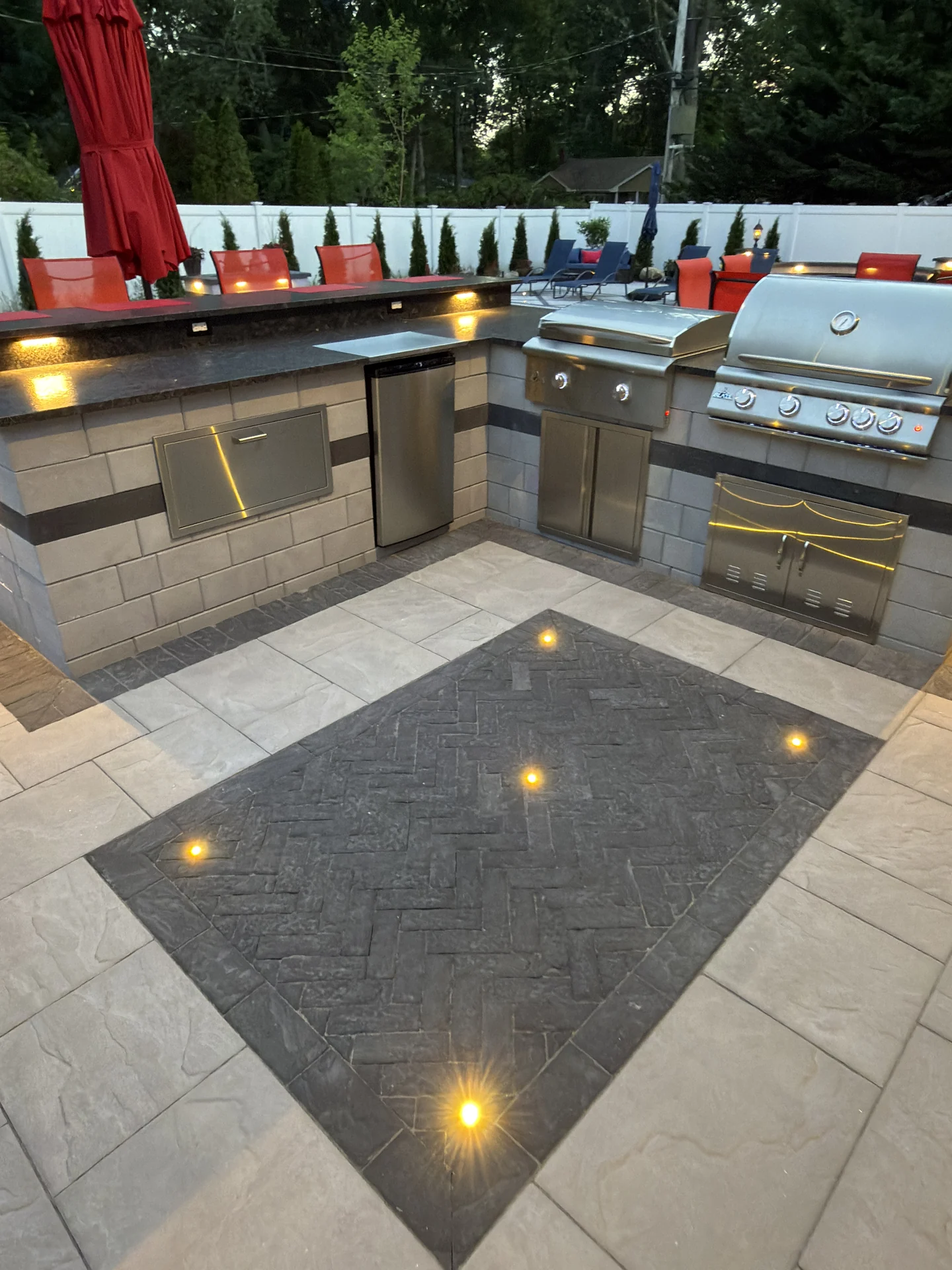 Built-in grills and the herringbone inset lit from the deck, Nesconset