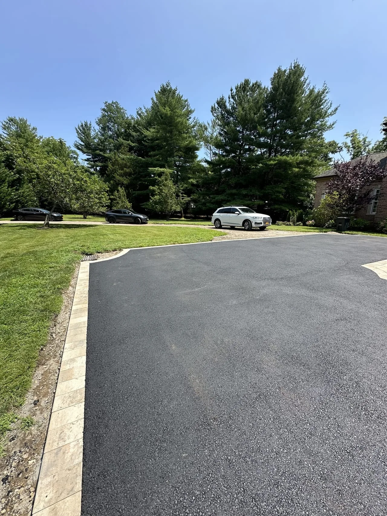 Paver border detail along estate driveway curve in Lloyd Harbor