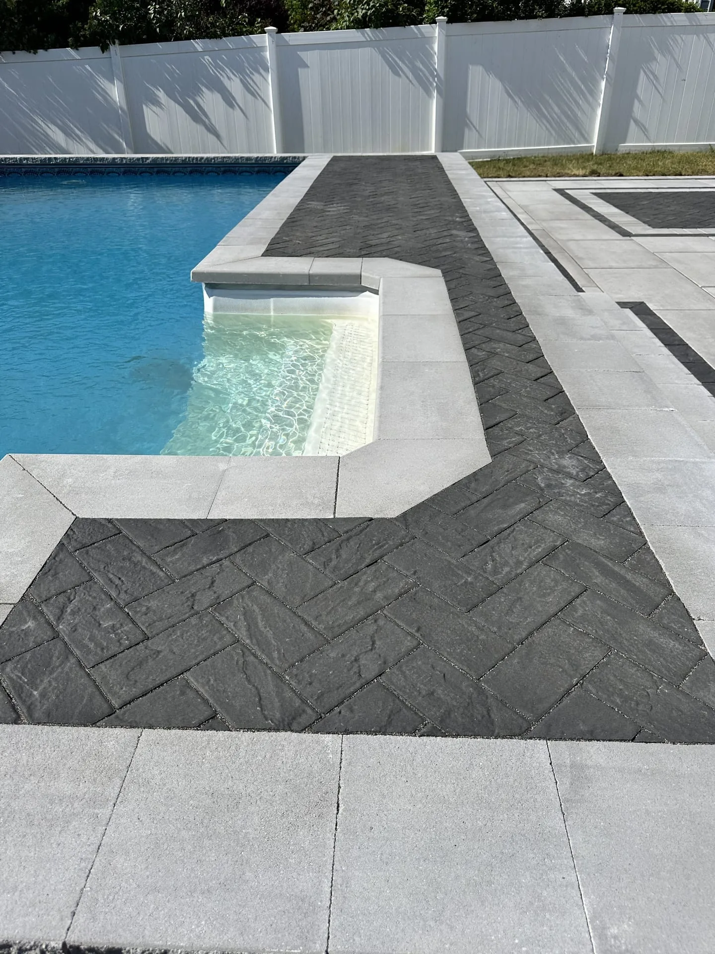 Herringbone paver border detail with pool waterfall spillover