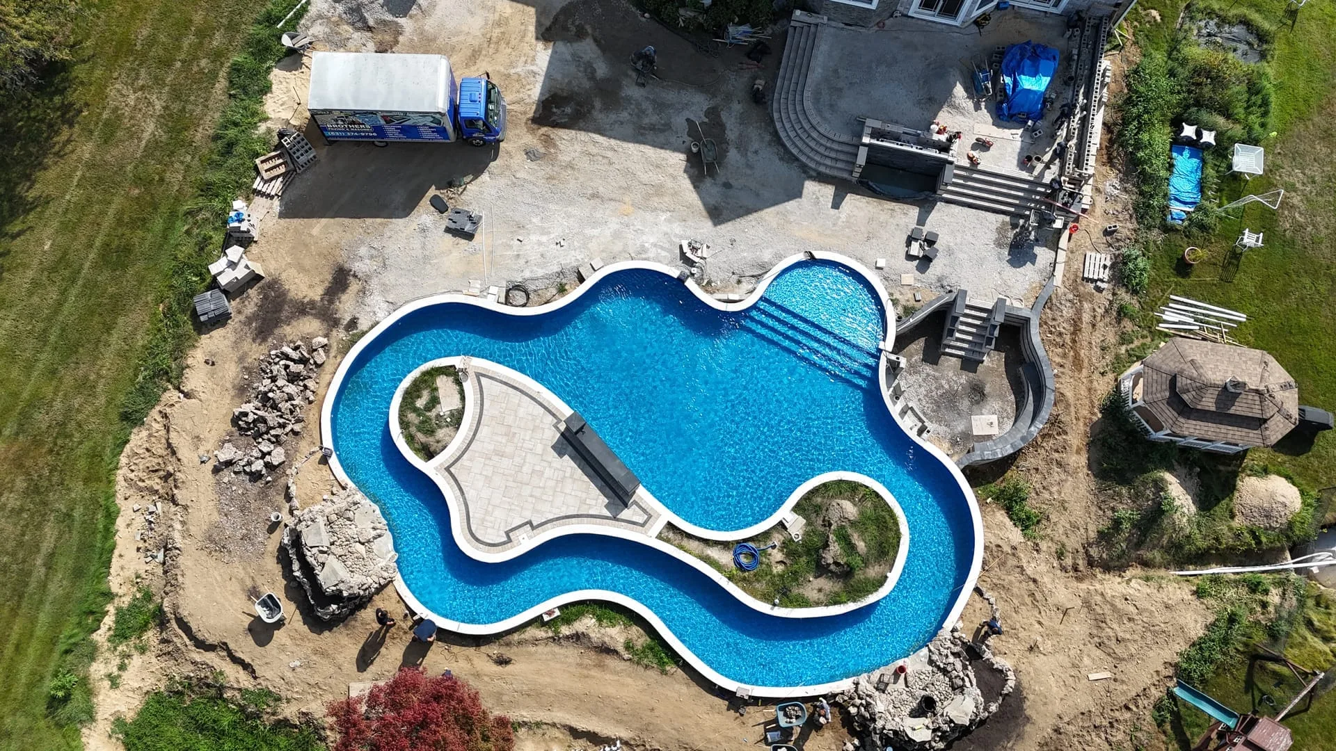 Pool patio with outdoor kitchen island in Commack, Long Island