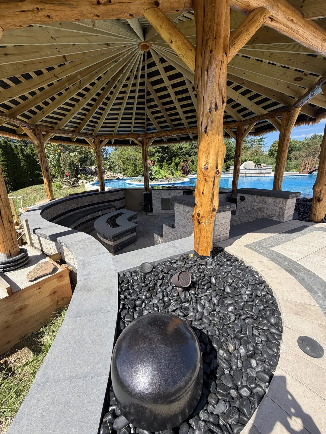 Sphere water feature on river rock beside the palapa, East Northport