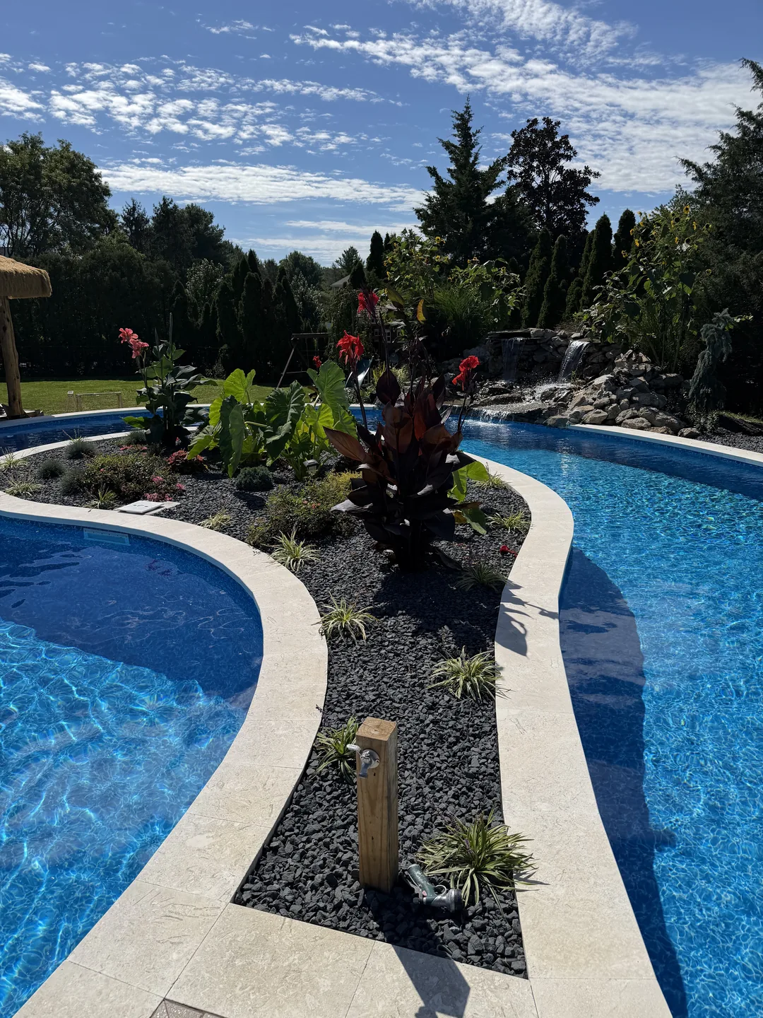 Planting and stone edge along the pool, East Northport
