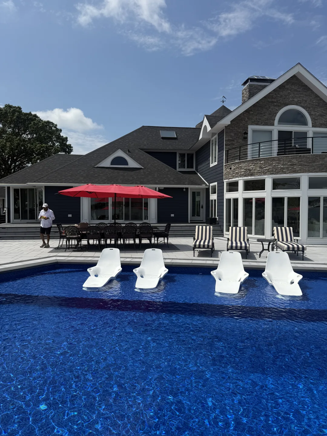 House, pool and loungers across the finished rear yard, Great River