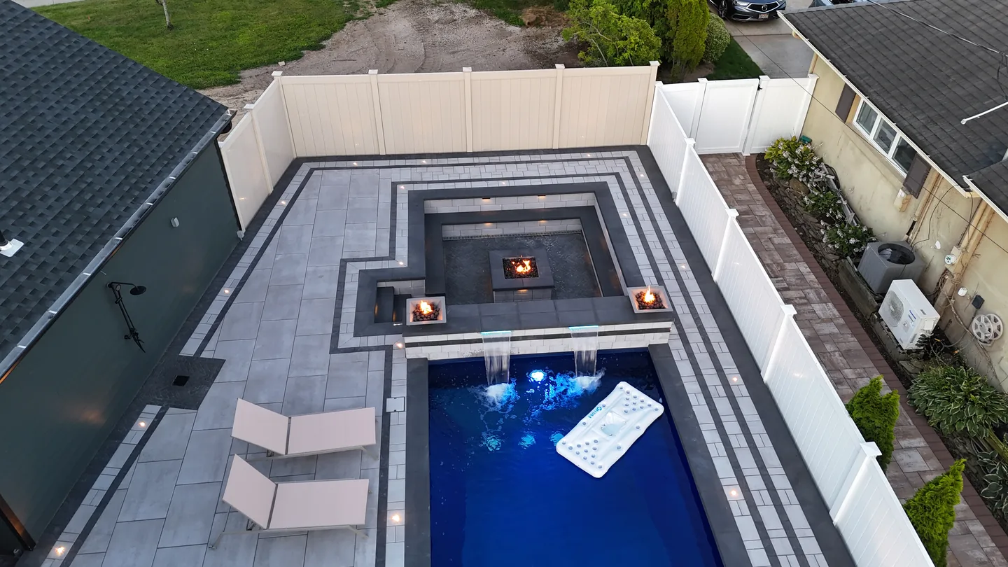 Overhead of the raised spa, pool and twin fire bowls at dusk, Massapequa