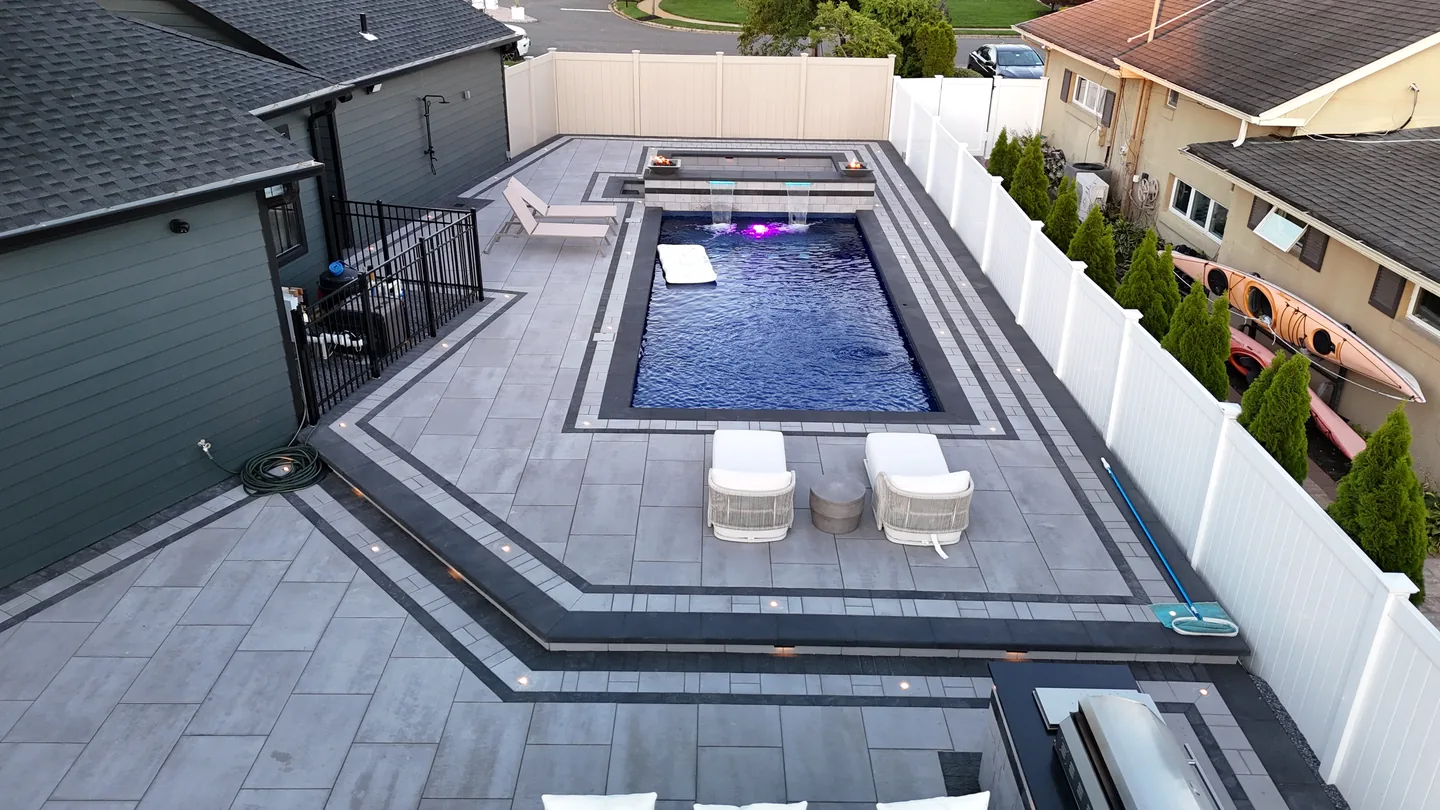 Pool deck with loungers and banded borders, Massapequa
