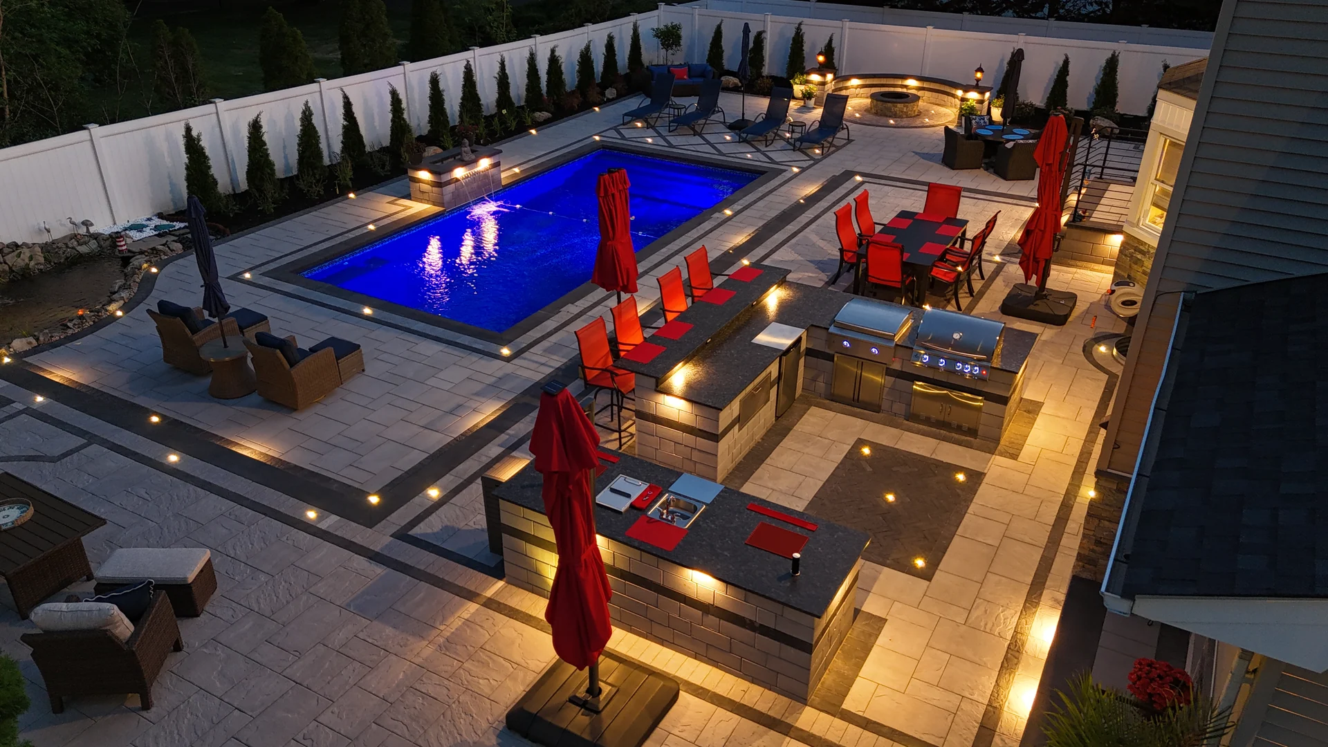 Wide blue-hour aerial of the finished rear yard, Nesconset
